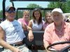 Kent Haughton and three visiting "Guthrie Girls" catch a ride with Hal Guthrie at the Chris Guthrie Memorial Golf Tournament.