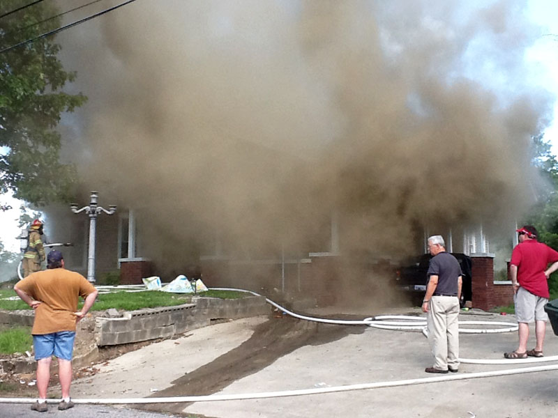 Smoke billows from a home on Alabama Avenue Wednesday afternoon