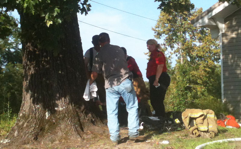 RPS Paramedics examine a Pebble firefighter Wednesday afternoon before transporting him to Lakeland Community Hospital with a possible heat-related injury